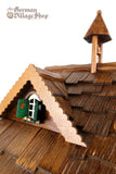 Cuckoo Clock Quartz - Musical Chalet with Shepherd and Sheep  German Cuckoo Clock battery operated black forest chalet with moving shepherd and music - close up of bell tower