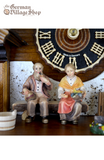 Cuckoo Clock Mechanical 8 Day - Hones Chalet & Wood Carver German Cuckoo Clock 8 day mechanical Hones chalet featuring black forest scene. Couple sitting on bench in front of chalet