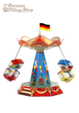 Circus Carousel - German Tin Toy Spinning tin carousel with fun fair illustraions, all carousel carriages are blurred spinning around the toy.