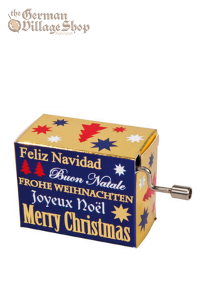 A rectangular music box with a silver hand crank extruding from the side. The box is navy blue with text on it. The text are names of Christmas Carols.