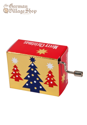 A rectangular music box with a silver hand crank extruding out the side. The box is gold and red with Christmas trees on it. The side text says Merry Christmas.