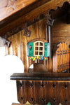German Cuckoo Clock battery operated black forest chalet with beer drinkers and music - green shutters on window