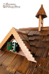  German Cuckoo Clock battery operated black forest chalet with moving shepherd and music - close up of bell tower