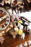 German Cuckoo Clock battery operated black forest chalet with moving beer drinker and music - close up of beer drinker