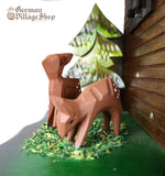 German Cuckoo Clock battery operated black forest chalet with see saw and music - close up of deer