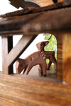 German Cuckoo Clock battery operated black forest chalet with wood sawyer men and music - close up of deer