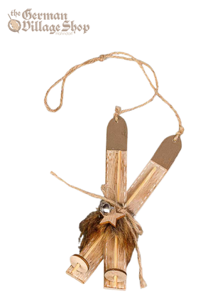 Pair of wooden snow skis with brown faux fur and bells attached. String from the top allows it to be hung as Christmas Tree Decoration.