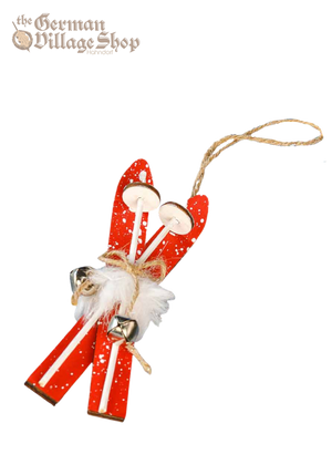 Pair of red snow skis with white faux fur and bells attached. String from the top allows it to be hung as Christmas Tree Decoration.