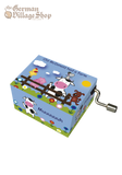 Small box with a silver handle extruding from side. Box has cartoon print of a farm with "Old McDonald had a farm" in text.