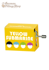 A  rectangular box with a silver hand crank extruding from it. The box is bright yellow and depicts the four Beatles band members, the text says Yellow Submarine.